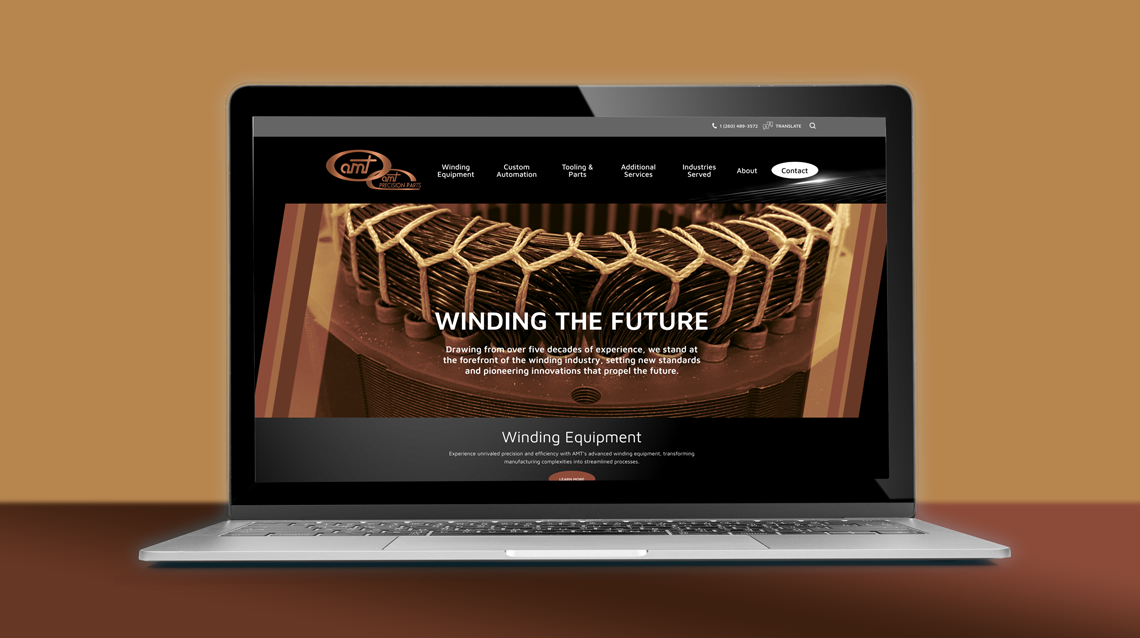 AMT Corporation website on a laptop