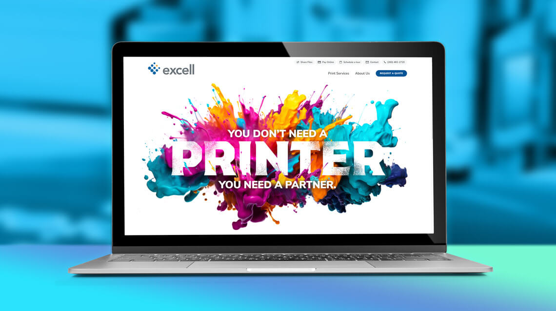 Excell Color Graphics website on a laptop